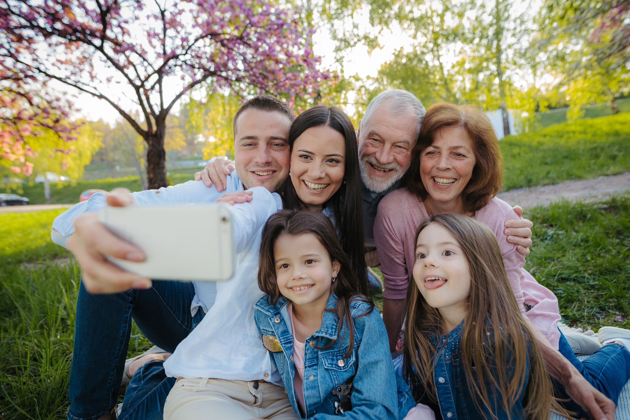 Multi-generational family taking a selfie together outdoors